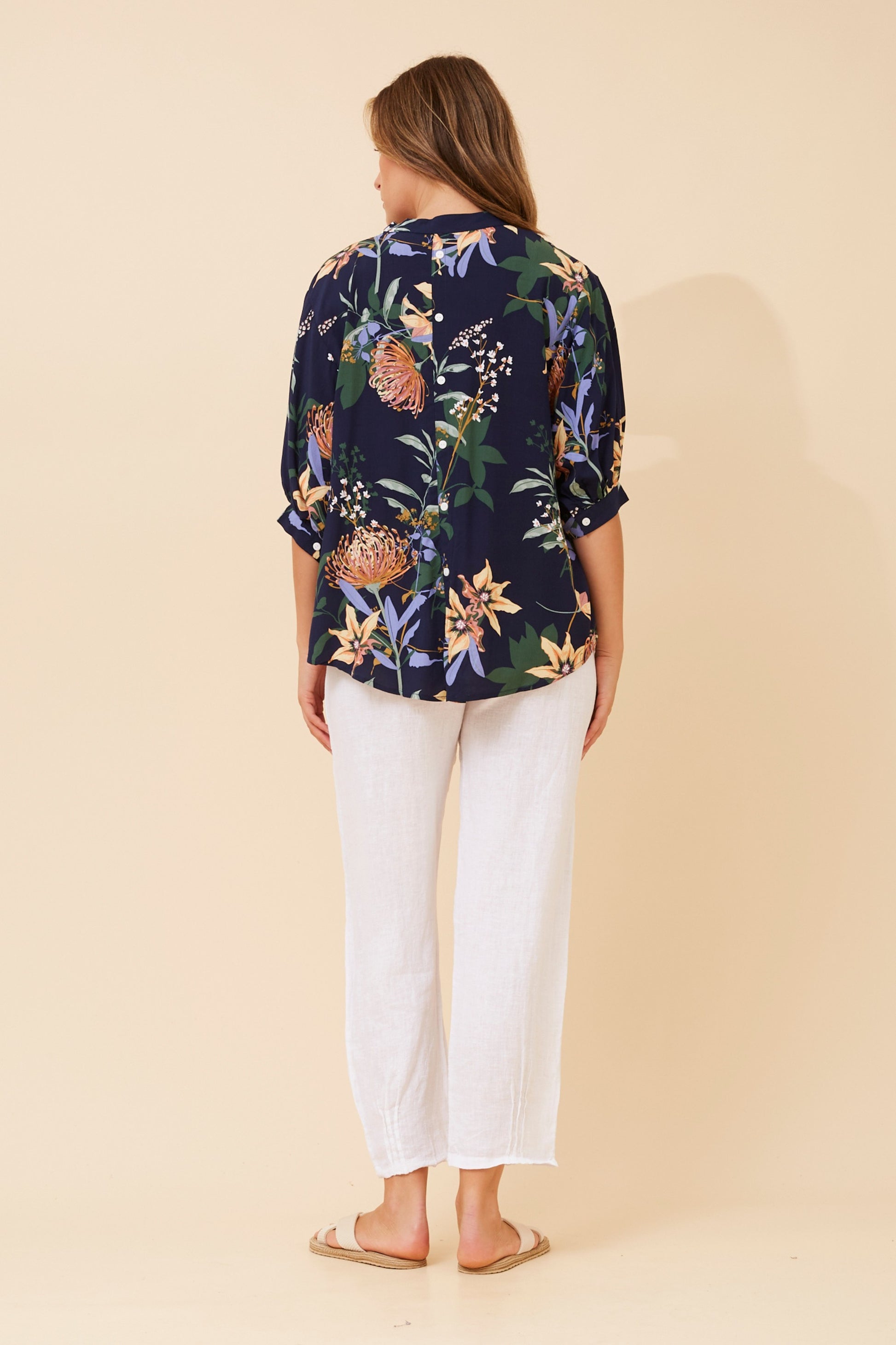 Shop the BELINA navy floral blouse featuring a breezy relaxed fit, partial button-down front, and lightweight breathable fabric.